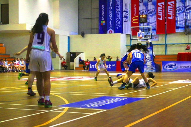 salah satu meain Untar terjatuh untuk mempertahankan bola