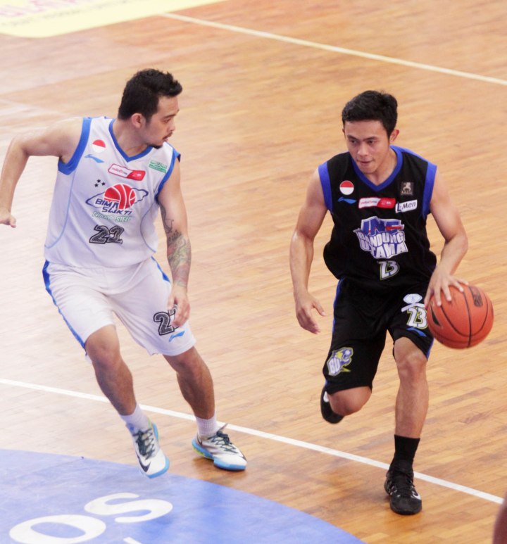 Point guard JNE BSC Bandung Utama Gian Gumilar (kanan) dan Made Indra Novrihadi (Bimasakti Nikko Steel Malang) dalam laga di GOR Sahabat, Semarang, Sabtu (7/3).